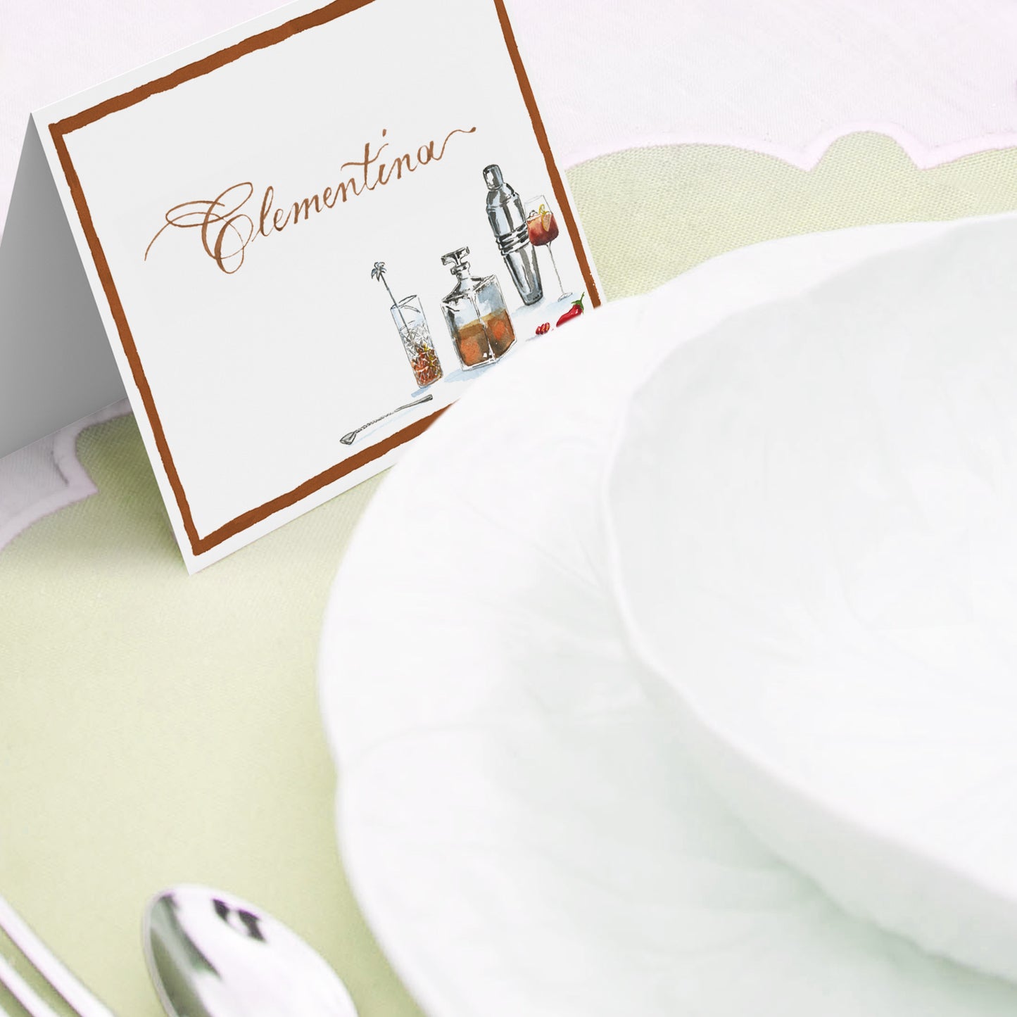 Image of a Clementina Sketchbook event place cards propped against a dining bowl.