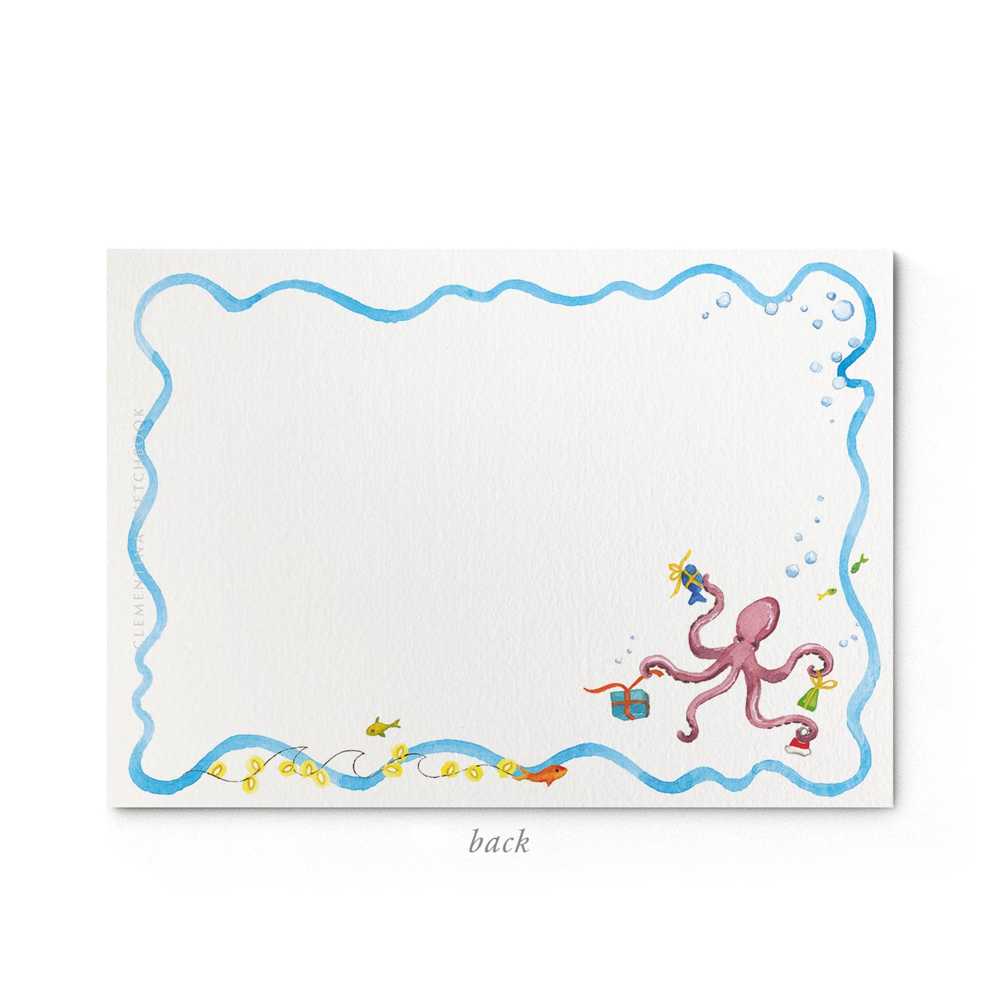 Image shows the back of a Clementina Sketchbook ocean themed stationery card, with a coral reef watercolour design and a blue wavy border.