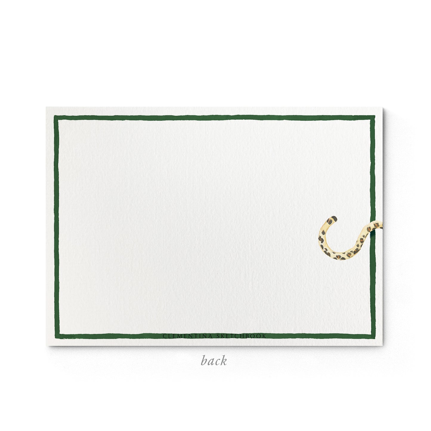 Image shows the back of a Clementina Sketchbook leopard print stationery card, with a leopard watercolour design and a green border.