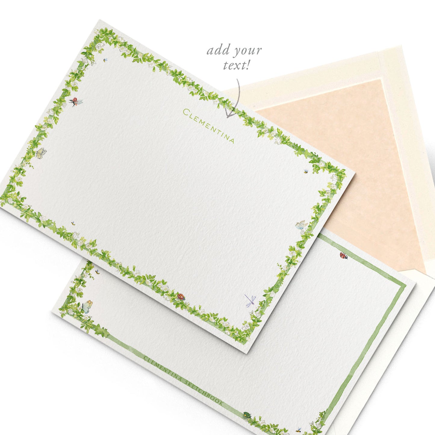 Image shows the back of a Clementina Sketchbook Enchanted Garden stationery card, with ladybugs, bees and butterflies flying around in watercolour design and a green border.