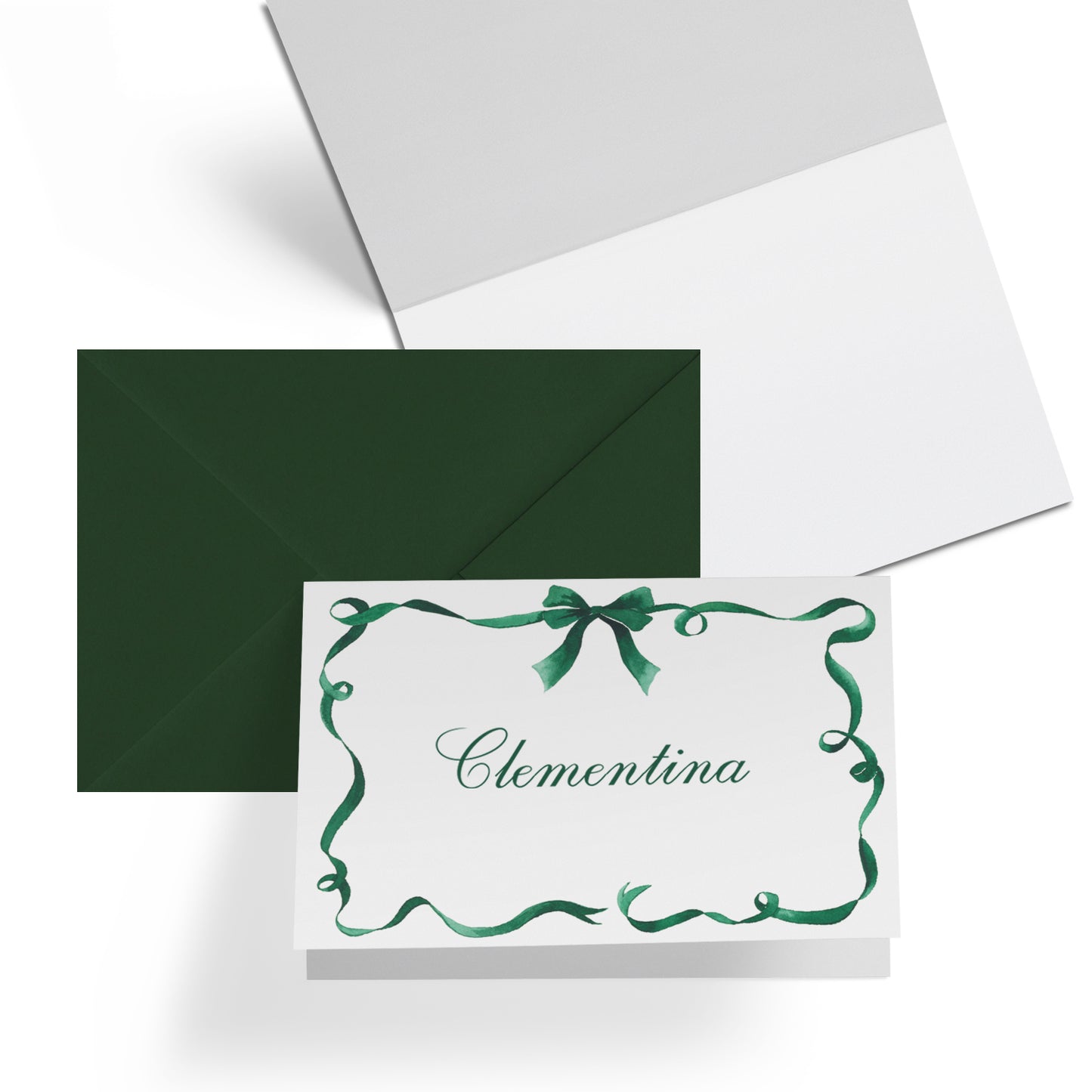 Close-up of a Clementina Sketchbook festive ribbon mini personal stationery card, showcasing the green ribbon watercolour designs, blank inside and dark green envelope. On the front of the card is personalised text, which reads "Clementina".