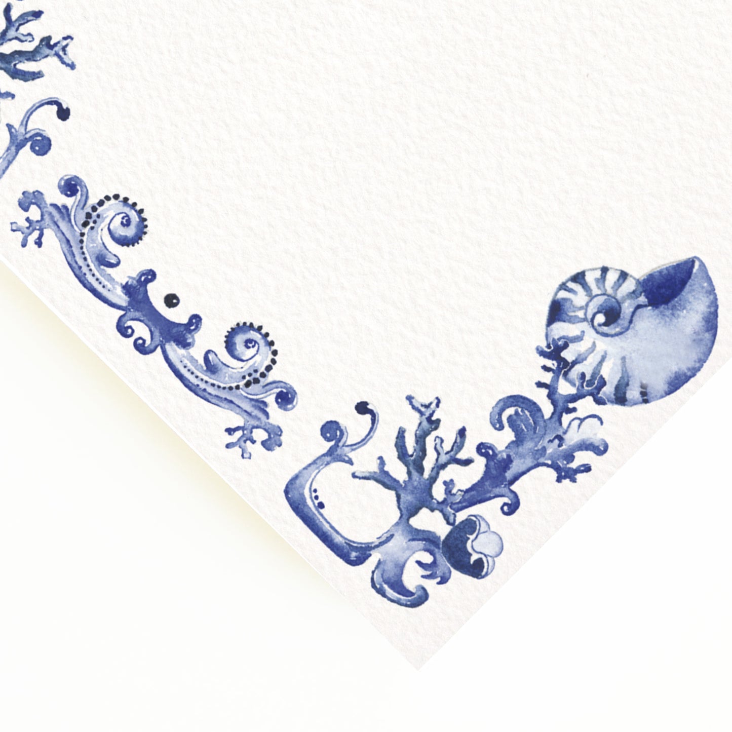 Close-up of the corner of our blue and white menu, the perfect personalised wedding menu, showcasing the seashell blue detailing.