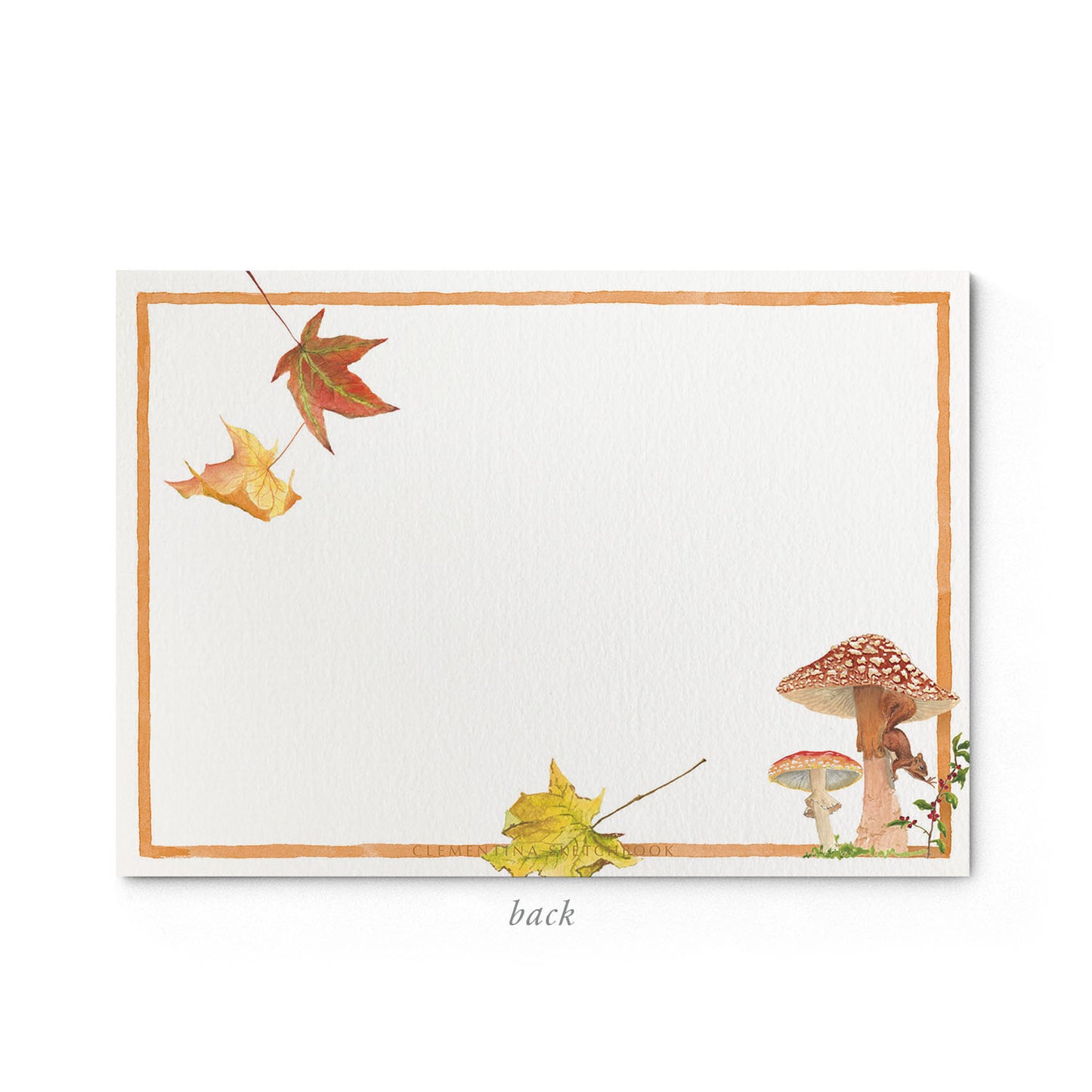 Image shows the back of a Clementina Sketchbook mushroom garden stationery card, with forest mushroom watercolour design and a dark orange border.