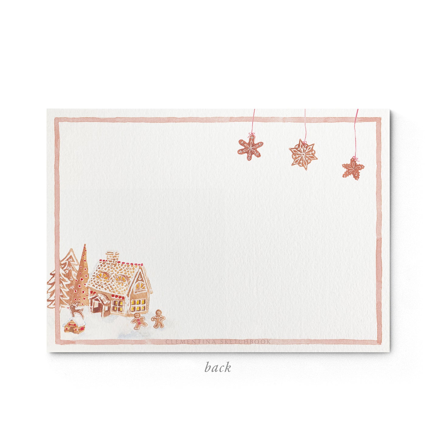 Image shows the back of a Clementina Sketchbook Christmas stationery card, with a gingerbread house watercolour design and a pale red border.