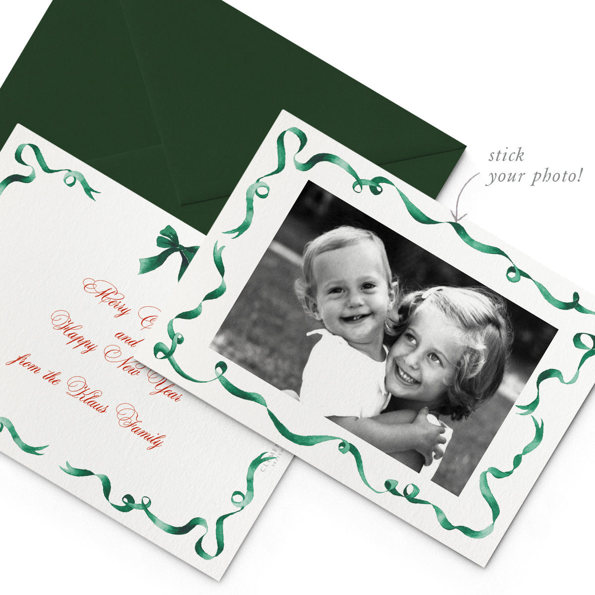 Image of both sides of Clementina Sketchbook's landscape festive ribbon personalised family card with a green ribbon border and a picture of two small girls in black and white.
