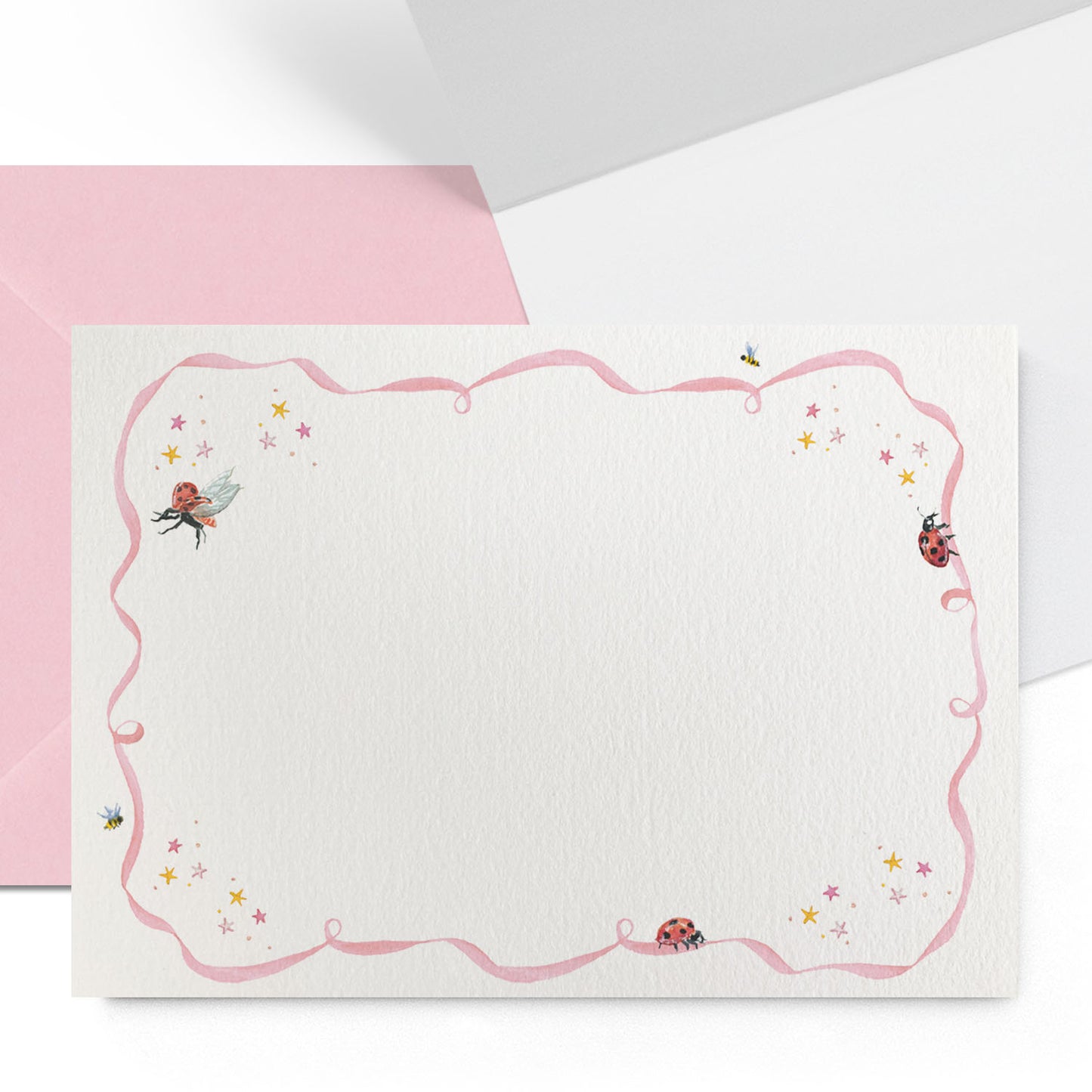 Close-up of the outside and inside of a Clementina Sketchbook ladybird personal stationery card with balloon watercolour designs, a light pink border and a light pink envelope.