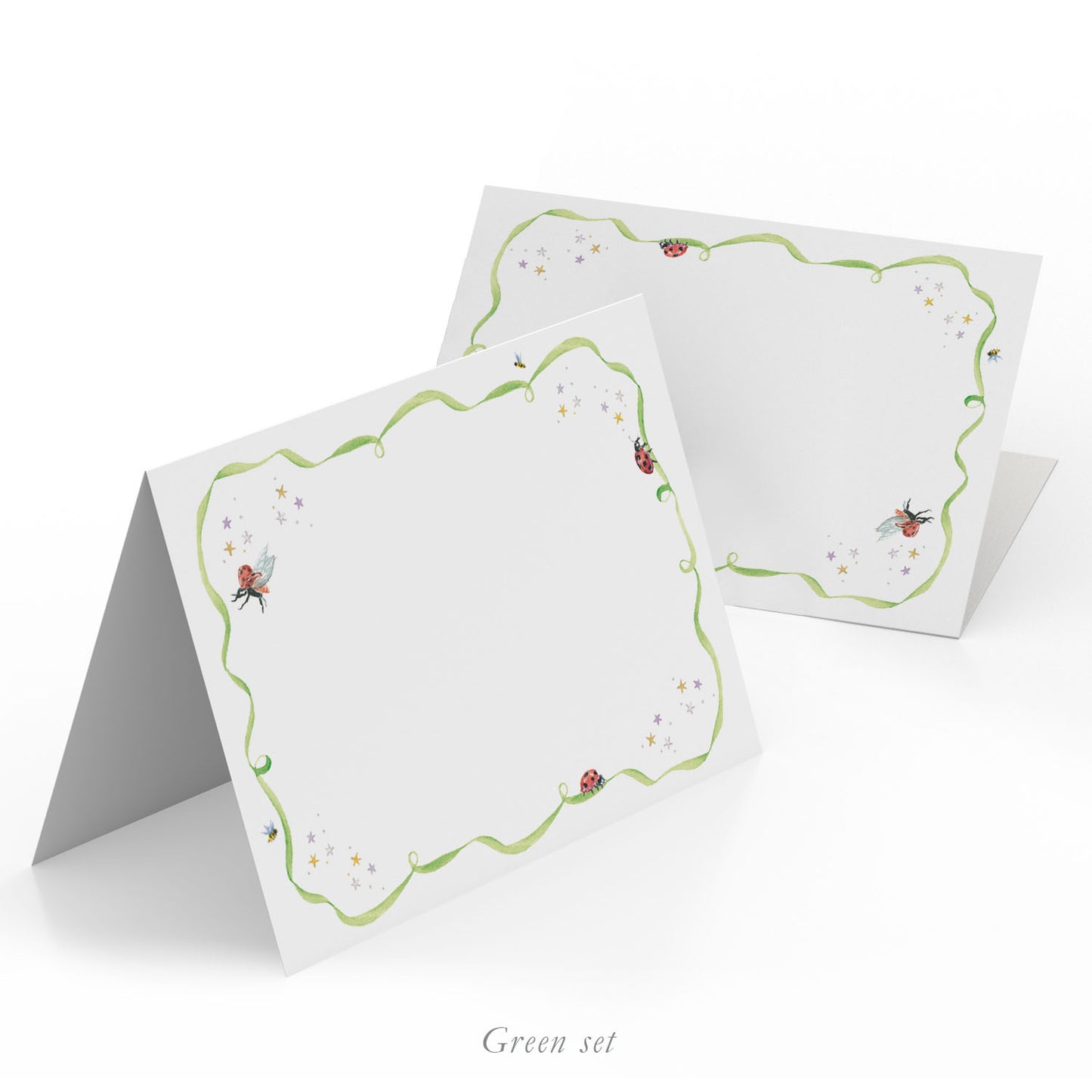 Image of two Clementina Sketchbook place cards, featuring green scalloped borders and hand-painted designs of ladybirds.