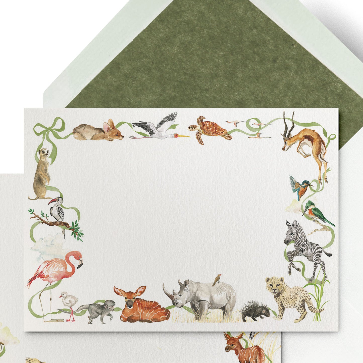 Close-up of Clementina Sketchbook's little African world stationery card with hand-painted watercolour designs and a green tissue envelope.
