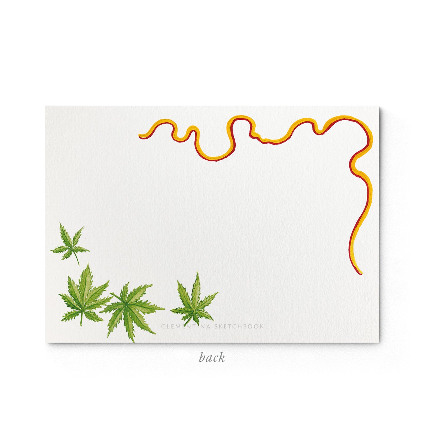 Image shows the back of a Clementina Sketchbook marijuana stationery card, with a cannabis watercolour design and an orange border.