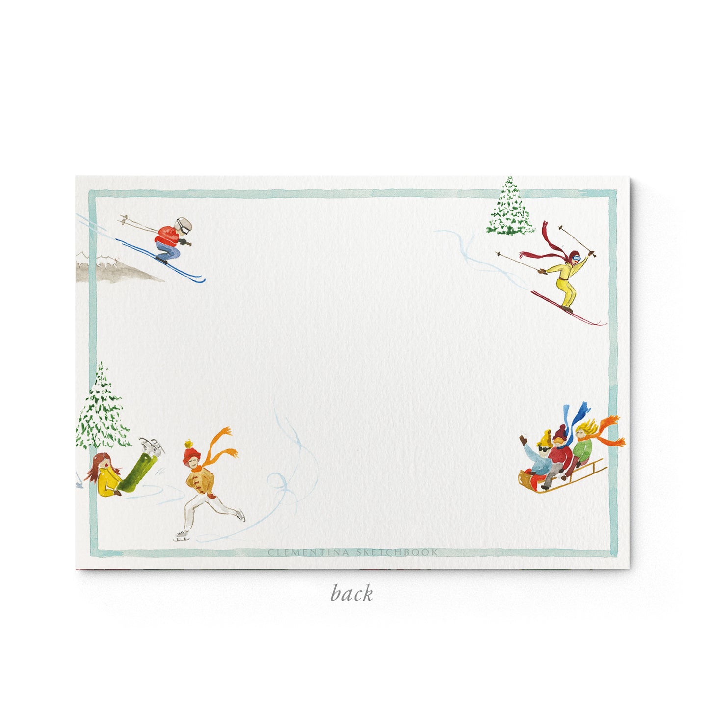 Image shows the back of a Clementina Sketchbook mountain stationery card, with a winter sports watercolour design and a light blue border.