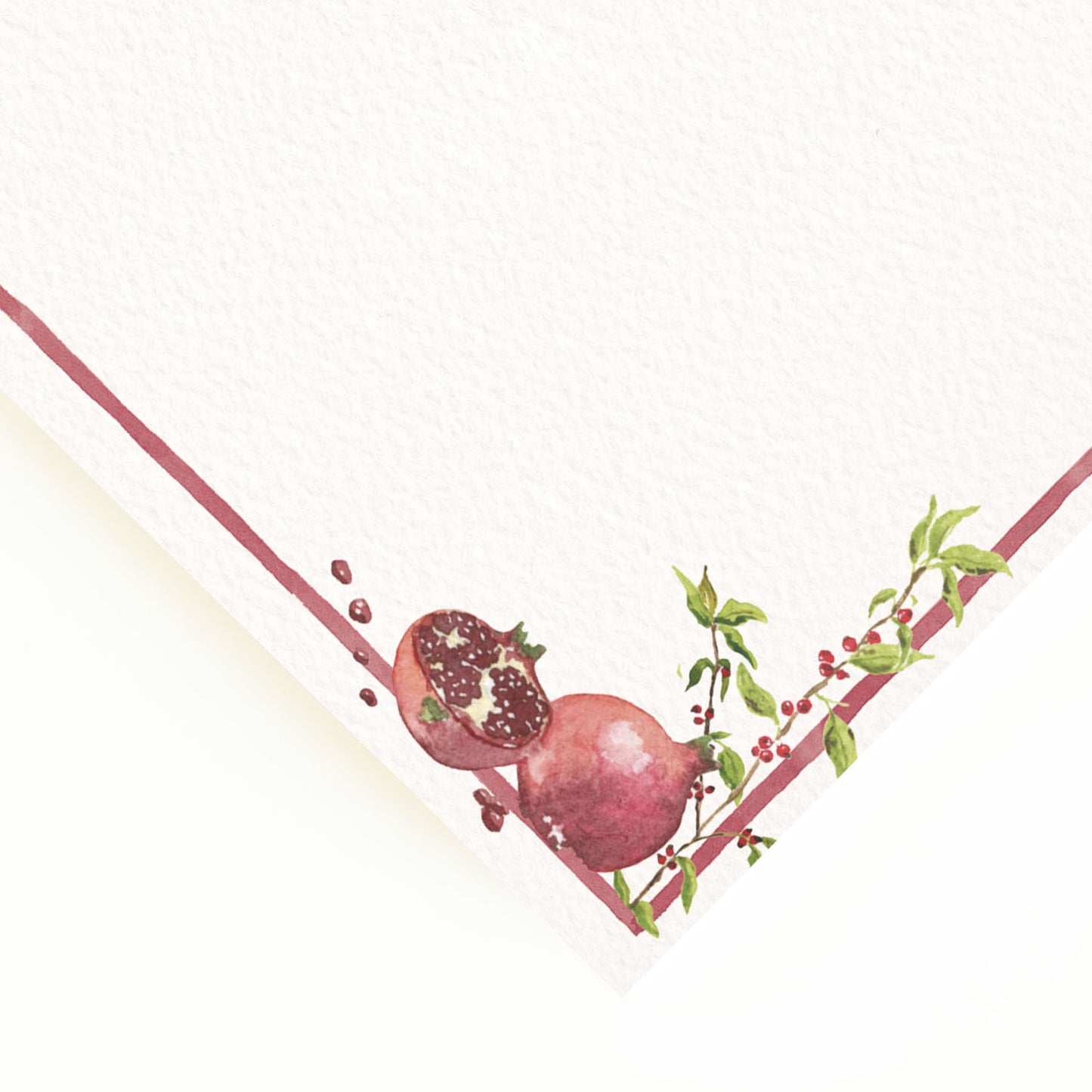 Close-up of the corner of our festive dinner menu, showcasing the menu's dark pink border and hand-painted watercolour designs.