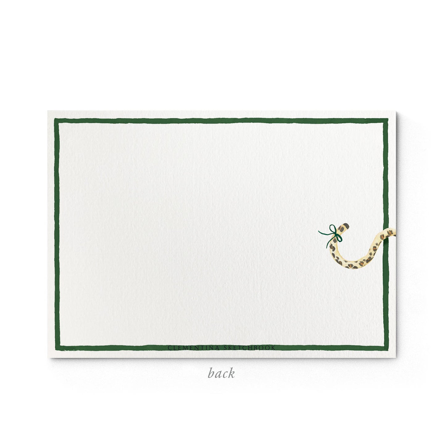 Image shows the back of a Clementina Sketchbook festive African animals print stationery card, with a safari watercolour design and a dark green border.