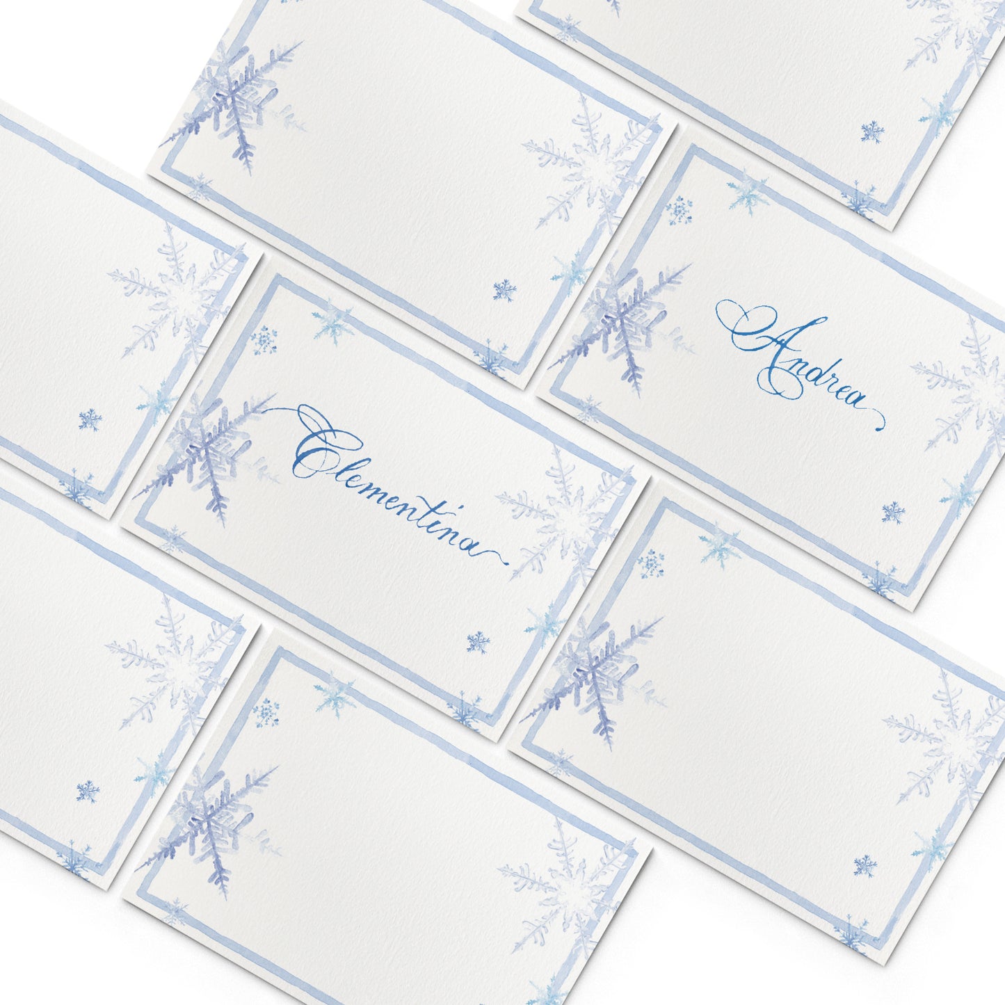 Image of multiple Clementina Sketchbook Christmas place cards, featuring hand-painted designs of snowflakes.