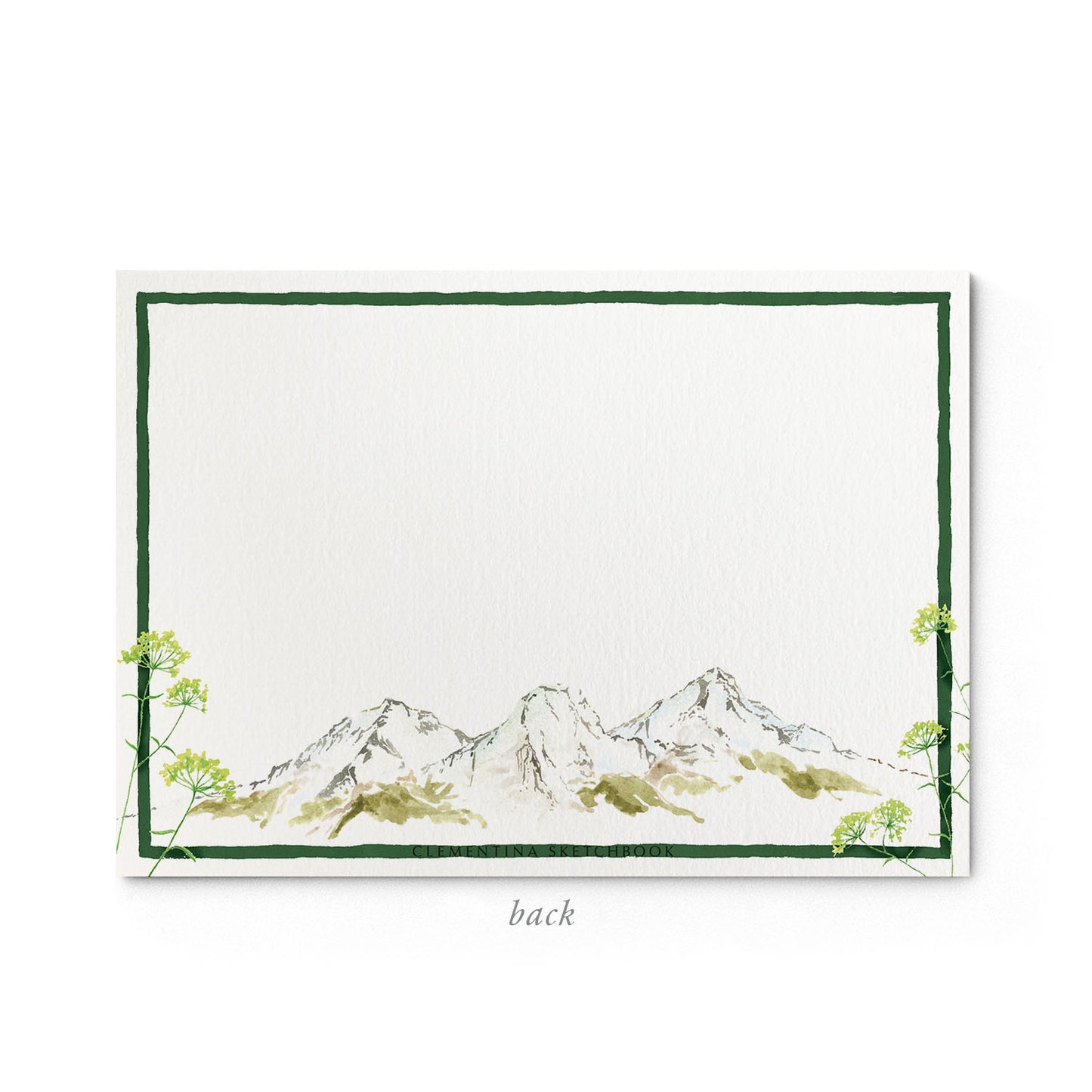 Image shows the back of a Clementina Sketchbook mountain stationery card, with a cow watercolour design and a green border.