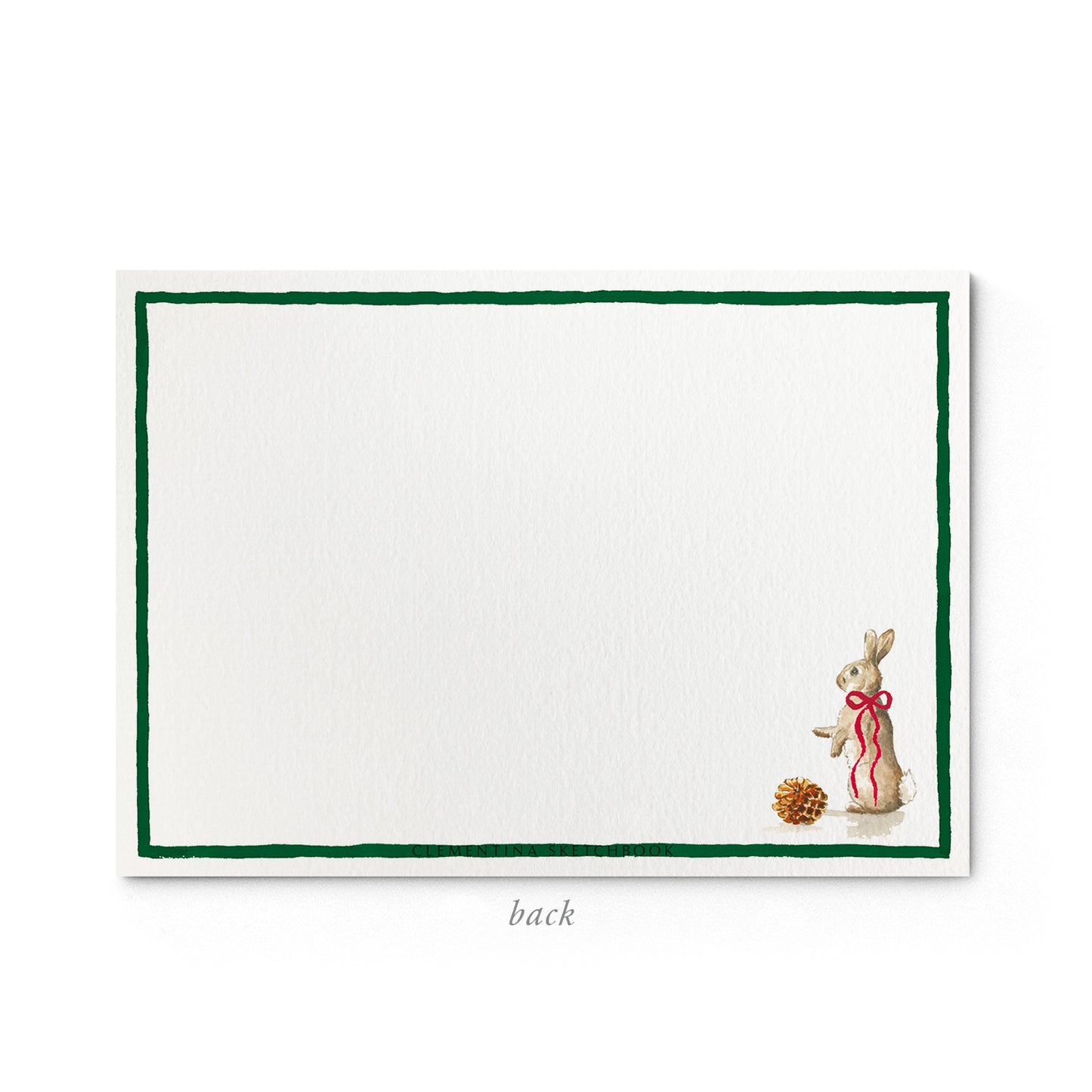 Image shows the back of a Clementina Sketchbook Christmas stationery card, with a forest animal watercolour design and a dark green border.