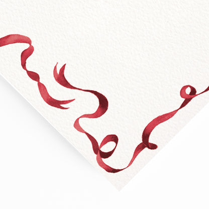 Close-up of the corner of our festive dinner menu, showcasing the menu's dark red ribbon border and hand-painted watercolour designs.