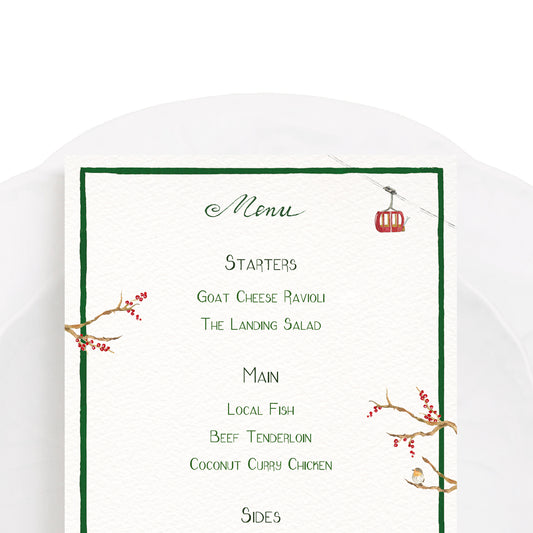 Close-up of our festive holiday menu, featuring a green border, winter berries and ski-lifts.