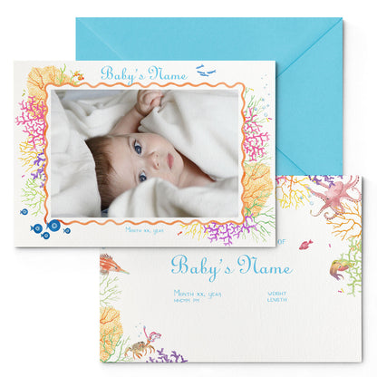 Image of both sides of Clementina Sketchbook's coral reef printed birth announcement with a reef border, personalised text, space for a baby photo to be stuck and a blue envelope.