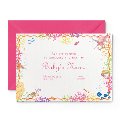 Image of Clementina Sketchbook's coral reef printed birth announcement, with a multicoloured coral border, pink personalised text and a pink envelope.