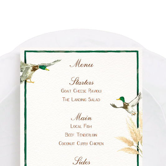 Close-up of our countryside birds menu, featuring personalised text, a green border and hand-painted watercolour designs.
