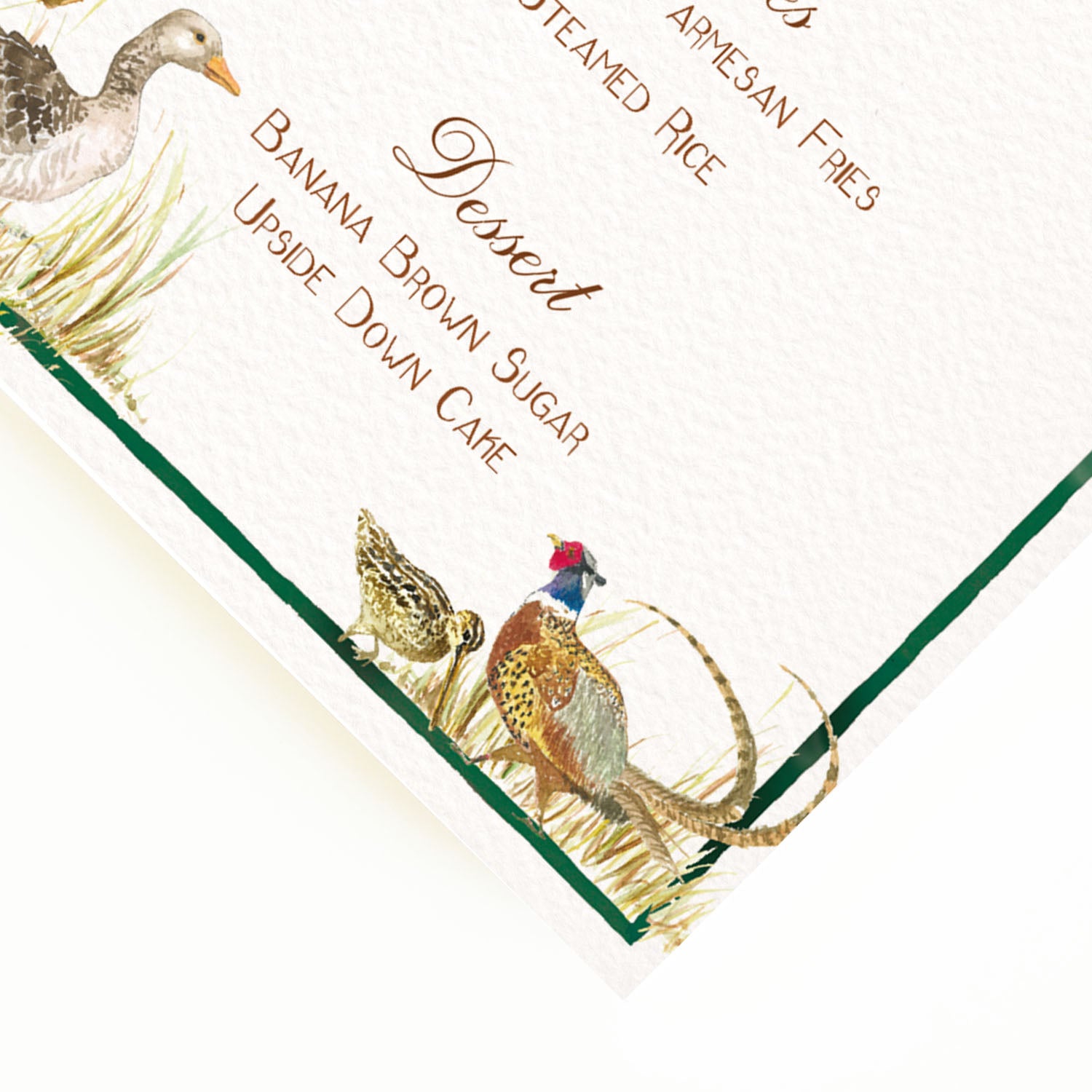 Close-up of the corner of our countryside birds menu, the perfect personalised wedding menu, showcasing the menu's green border and custom designs of birds.