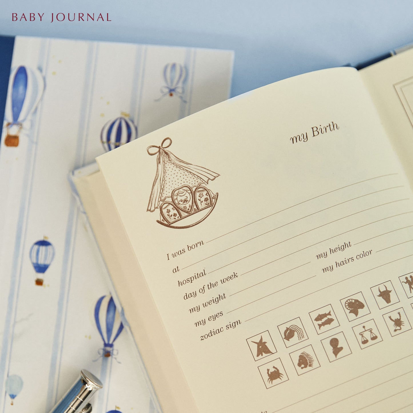 Close-up of the bundle's baby journal featuring templated pages for parents to fill in.