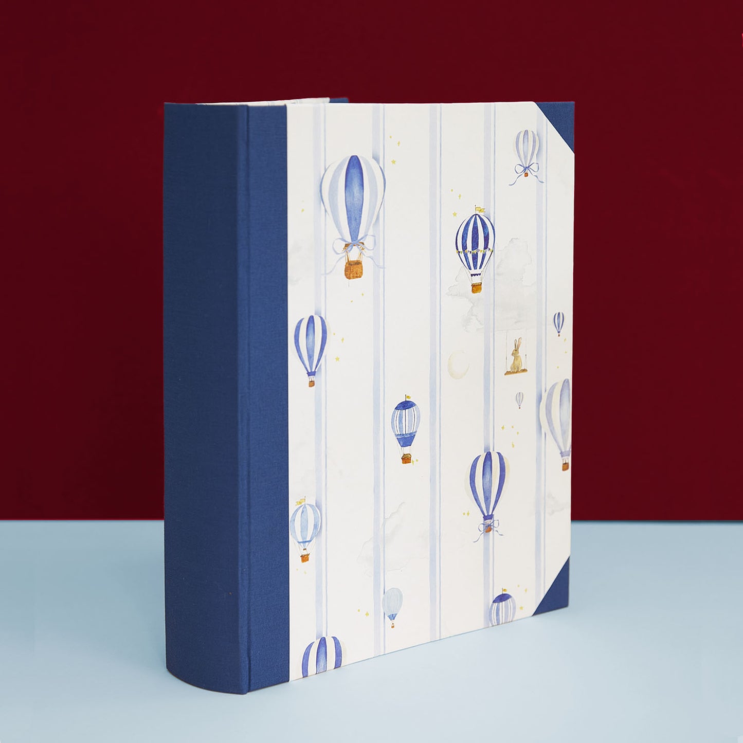 Image of the hot air balloon baby book bundle in blue, featuring hand-painted watercolour designs.      