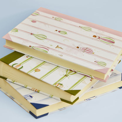Stack of Hot Air Balloons memory books in light pink, light blue and green, perfect as baptism or christening photo albums.