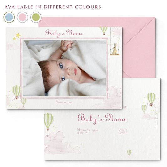 Image of both sides of Clementina Sketchbook's hot air balloon printed birth announcement with a pink border, personalised text, space for a baby photo to be stuck and a green envelope. In the corner of the image is a colour wheel showing the different colours the personalised birth announcement is available in: green, pink and blue.                                                                                                                  