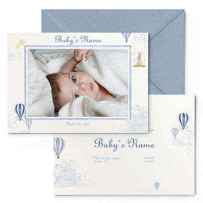 Image of both sides of Clementina Sketchbook's hot air balloon printed birth announcement with a blue border, personalised text, space for a baby photo to be stuck and a blue envelope.