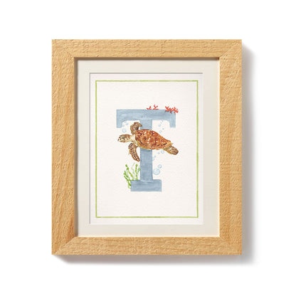 Close-up of the african animals print. This inital print features a unique watercolour design for the letter T, which has been placed in a wooden frame.