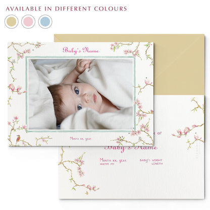  Image of both sides of Clementina Sketchbook's magnolia printed birth announcement with a floral border, personalised text, space for a baby photo to be stuck and a yellow envelope. In the corner of the image is a colour wheel showing the different colours the personalised birth announcement is available in: sand, pink and blue.