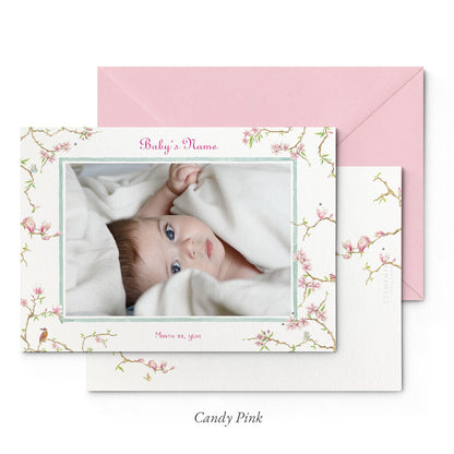 Image of both sides of Clementina Sketchbook's magnolia printed birth announcement with a floral border, personalised text, space for a baby photo to be stuck and a pink envelope.