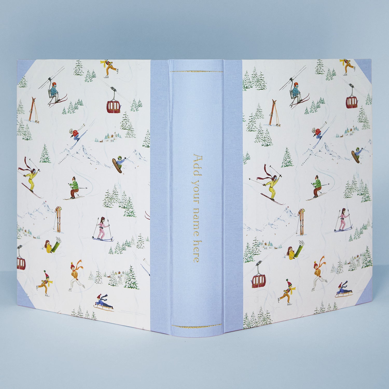 Detail of Mountain Activities album corner showing fabric binding and hand-painted alpine artwork, personalised family photo album.