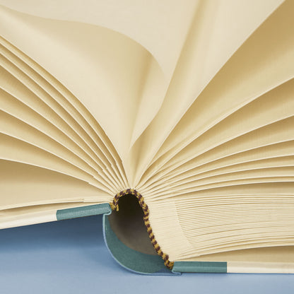 Close up of open Shells on Shells holiday photo album showing luxe Italian paper and tissue-lined pages.