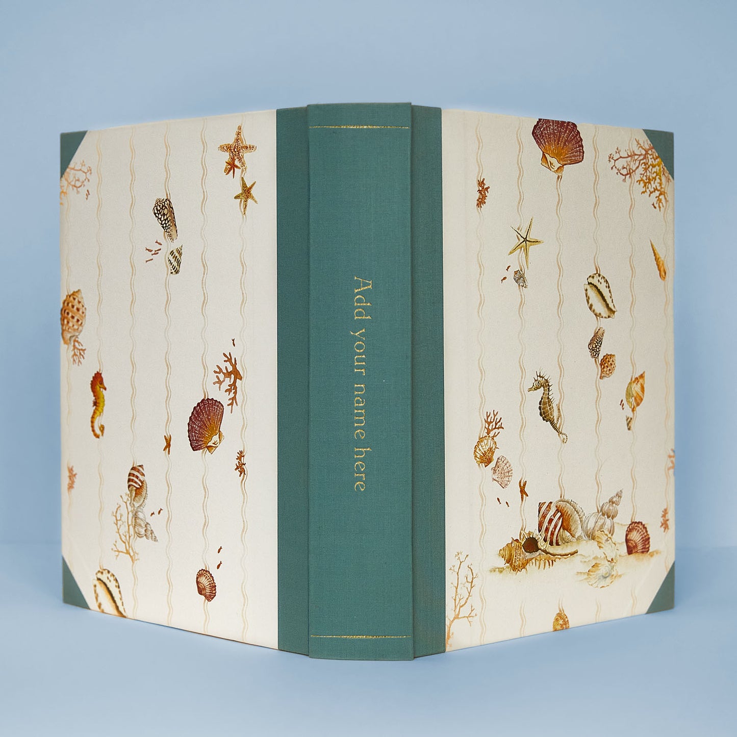 Open Shells on Shells personalised photo album with turquoise binding, showing gold foiling option on the spine, ideal as a wedding photo album or memory book.