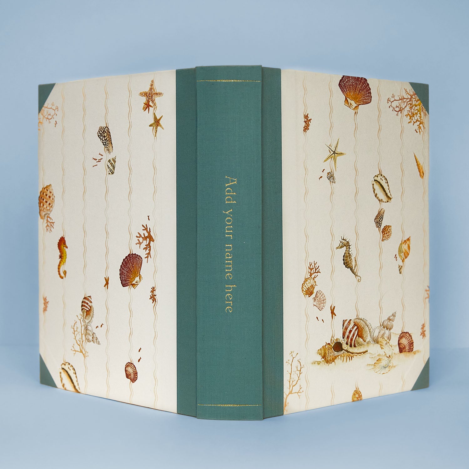 Open Shells on Shells personalised photo album with turquoise binding, showing gold foiling option on the spine, ideal as a wedding photo album or memory book.