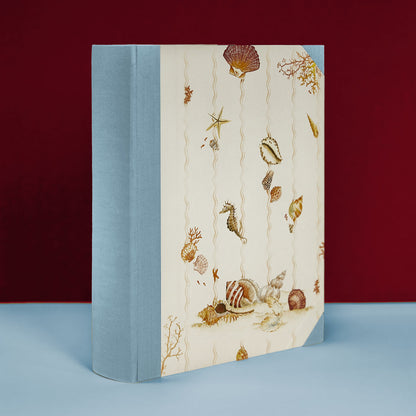 Light blue Shells on Shells family photo album with ocean-themed hand-painted illustrations, handmade in Italy.