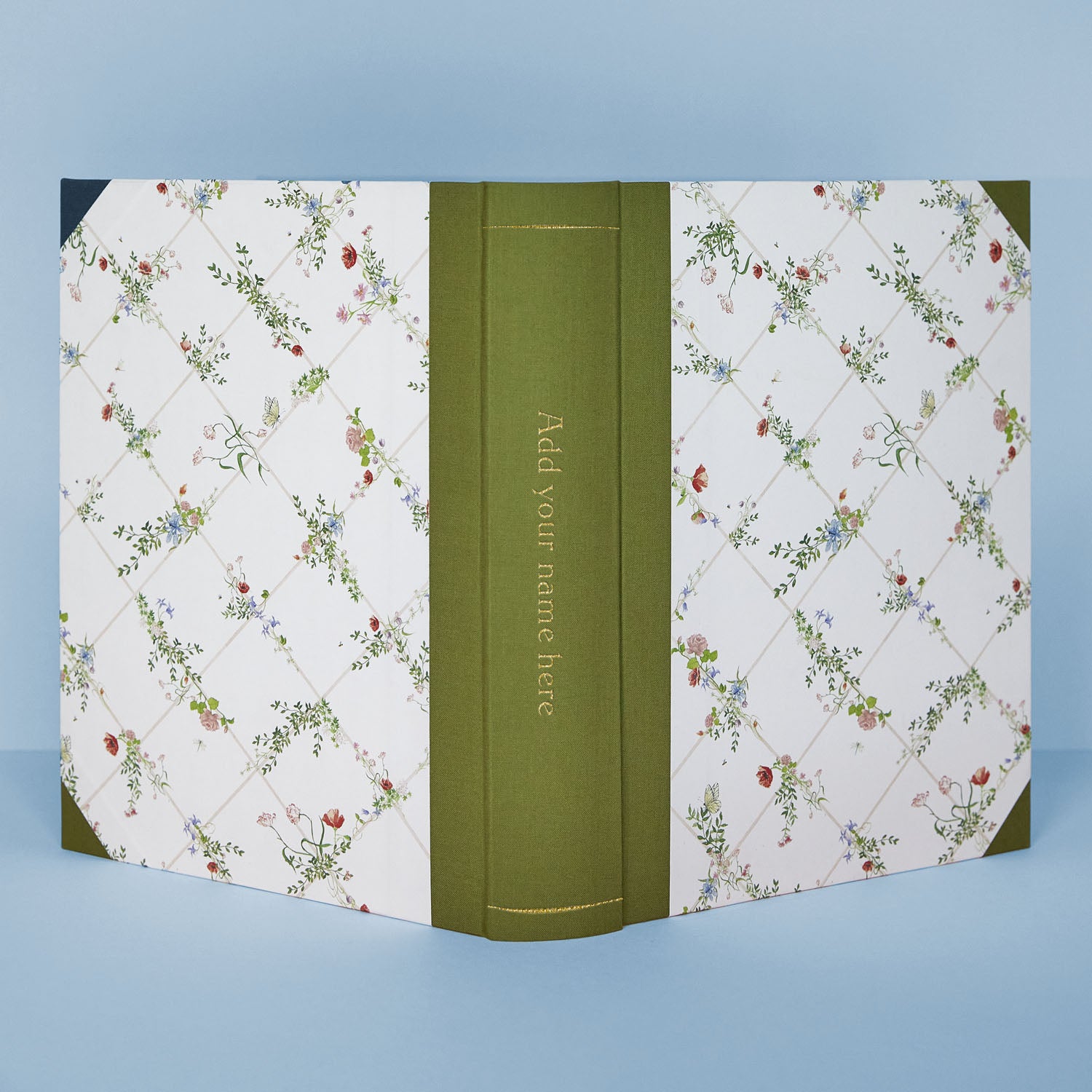 Detail of Wild Blooms photo album corner with green binding and hand-painted flowers, part of Clementina’s personalised wedding photo albums.