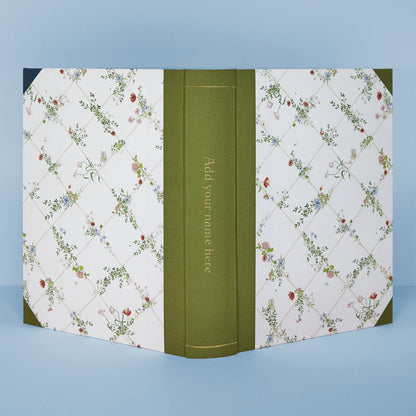 Detail of Wild Blooms photo album corner with green binding and hand-painted flowers, part of Clementina’s personalised wedding photo albums.