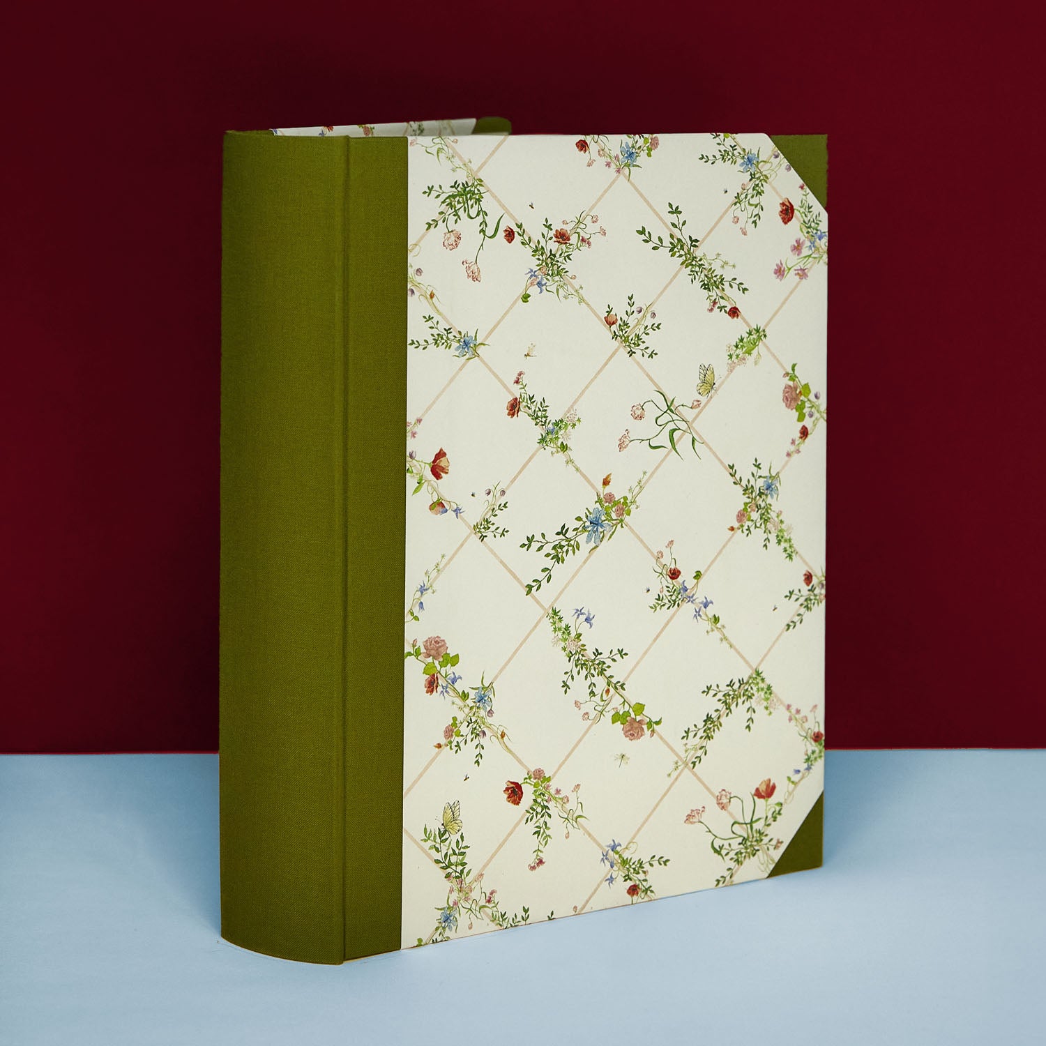 Green Wild Blooms wedding photo album standing upright, elegant floral memory book design.