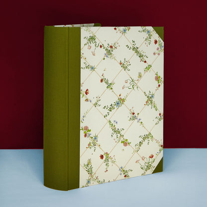 Green Wild Blooms wedding photo album standing upright, elegant floral memory book design.